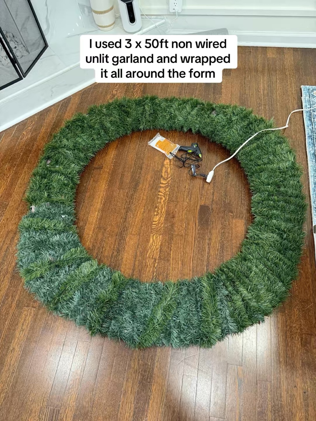 Wreath form fully wrapped in green garland